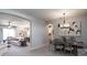 Elegant dining area with a view into the living room, featuring stylish furniture and decor at 6062 Barracuda Loop, Wimauma, FL 33598