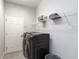 Practical laundry room equipped with modern appliances and storage shelves at 6062 Barracuda Loop, Wimauma, FL 33598