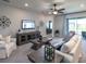 Comfortable living room featuring plush seating, modern ceiling fan, and entertainment center at 6062 Barracuda Loop, Wimauma, FL 33598