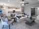 Spacious living room open to kitchen, featuring stylish furniture, and modern finishes at 6062 Barracuda Loop, Wimauma, FL 33598