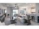 Open-concept living area with modern decor, connecting living room, dining area, and kitchen at 6062 Barracuda Loop, Wimauma, FL 33598