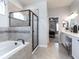 Luxurious bathroom featuring a soaking tub, separate shower, and dual sink vanity at 6062 Barracuda Loop, Wimauma, FL 33598