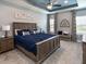 Serene main bedroom features a tray ceiling, ample natural light, and stylish furnishings at 6062 Barracuda Loop, Wimauma, FL 33598
