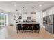 Modern kitchen with stainless steel appliances, white cabinets, and a dark, granite-topped island at 8538 Greenway Ave, Wesley Chapel, FL 33544