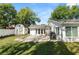 Wide shot of fenced backyard featuring a concrete patio, fire pit, storage shed, and room for entertaining at 4208 W Bay Vista Ave, Tampa, FL 33611