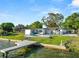 Picturesque waterfront home features a private dock and pool, set against a lush green landscape at 5104 Saint Charles Pl, Tampa, FL 33610