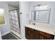 This bathroom showcases a white countertop vanity and a shower with a ship-themed curtain at 5104 Saint Charles Pl, Tampa, FL 33610