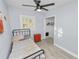 Small bedroom with tiled floors, ceiling fan, and closet at 5104 Saint Charles Pl, Tampa, FL 33610