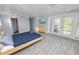 This bedroom features tile flooring, an ensuite bathroom, and sliding glass doors to outdoor views at 5104 Saint Charles Pl, Tampa, FL 33610