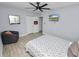 Cozy bedroom featuring a ceiling fan, wall mounted tv, closet, and comfortable chair at 5104 Saint Charles Pl, Tampa, FL 33610