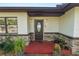 Inviting front entrance featuring a decorative door, stone accents, and well-maintained landscaping at 5104 Saint Charles Pl, Tampa, FL 33610