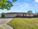Charming single-Gathering home with well-manicured lawn, modern design, and attached garage at 5104 Saint Charles Pl, Tampa, FL 33610