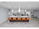 Large kitchen island with seating and pendant lighting, open to the living area in a bright, modern design at 5104 Saint Charles Pl, Tampa, FL 33610