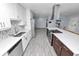 Bright kitchen featuring white cabinets, stainless steel appliances, an island, and stylish backsplash at 5104 Saint Charles Pl, Tampa, FL 33610
