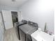 Functional laundry area features modern washer, dryer, utility sink, and white wood flooring for convenience at 5104 Saint Charles Pl, Tampa, FL 33610