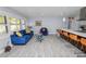 Bright and airy living room adjacent to kitchen with modern tile flooring and lots of natural light at 5104 Saint Charles Pl, Tampa, FL 33610
