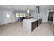 Modern living space with a kitchen island, comfortable seating, and plenty of natural light at 5104 Saint Charles Pl, Tampa, FL 33610