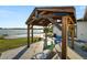 Inviting outdoor patio with grill overlooks the pool and waterfront, perfect for relaxing or entertaining at 5104 Saint Charles Pl, Tampa, FL 33610
