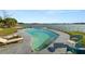 Backyard pool and lake, plus patio seating at 5104 Saint Charles Pl, Tampa, FL 33610