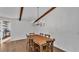 Dining room with wooden table and chairs, exposed beams, and wood paneling at 7205 Anacapa Ln, Plant City, FL 33565