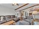 Open-concept living room with hardwood floors, exposed beams, and a view of the kitchen at 7205 Anacapa Ln, Plant City, FL 33565