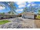 Spacious backyard featuring a brick-paved area, a small patch of grass, and a detached garage at 923 26Th N St, St Petersburg, FL 33713
