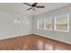 Bright bedroom featuring three windows with blinds and dark wood laminate flooring at 923 26Th N St, St Petersburg, FL 33713