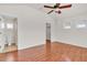 Bedroom with vaulted ceiling, ceiling fan, wood floors, and ensuite bathroom and closet at 923 26Th N St, St Petersburg, FL 33713