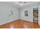 Inviting bedroom with wood floors, large window, and a door to the outside at 923 26Th N St, St Petersburg, FL 33713
