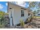 Home exterior showing a side view, detailed landscaping, and side entrance at 923 26Th N St, St Petersburg, FL 33713