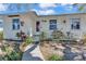 Charming home featuring a red door, lush landscaping, and a stone walkway leading to the entrance at 923 26Th N St, St Petersburg, FL 33713