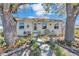 Cozy home with mature trees, landscaped garden beds, and a inviting red door at 923 26Th N St, St Petersburg, FL 33713
