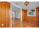 Stylish Gathering room with wood-paneled walls, hardwood floors, and seamless flow to other areas at 923 26Th N St, St Petersburg, FL 33713