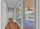Hallway with wood floors leading to a bright screened porch at 923 26Th N St, St Petersburg, FL 33713