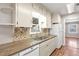 Kitchen features granite countertops, tiled backsplash, white appliances, and wood flooring at 923 26Th N St, St Petersburg, FL 33713