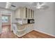 Eat-in kitchen features white cabinets, solid-surface countertops, and stainless steel microwave at 923 26Th N St, St Petersburg, FL 33713