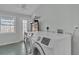 Bright laundry room featuring a washer, dryer, and door to backyard at 923 26Th N St, St Petersburg, FL 33713