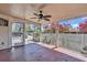 Covered patio featuring a ceiling fan and views of the backyard with pink flowering bushes at 923 26Th N St, St Petersburg, FL 33713