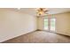 Bedroom with carpeted floors and glass door to the outdoor space at 10760 S County Road 39, Lithia, FL 33547