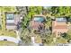 Aerial view of a neighborhood featuring mature trees and several homes with screened-in pools at 1316 Cambron Dr, Valrico, FL 33596