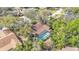 Aerial view of a beautiful home with a screened pool and lush greenery and trees at 1316 Cambron Dr, Valrico, FL 33596