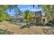The backyard has a screened-in pool with trees surrounding the back at 1316 Cambron Dr, Valrico, FL 33596
