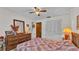 Bright bedroom featuring a large dresser and a closet, and a ceiling fan at 1316 Cambron Dr, Valrico, FL 33596