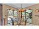 Breakfast nook with a glass table, seating and sliding glass doors to the backyard at 1316 Cambron Dr, Valrico, FL 33596