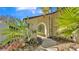 Arched entryway with lush, green tropical landscaping creates an inviting approach at 1316 Cambron Dr, Valrico, FL 33596