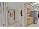 Hallway leads to a well-lit kitchen area, showcasing the home's practical layout and design at 1316 Cambron Dr, Valrico, FL 33596