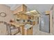 Well-lit kitchen with a breakfast bar, modern appliances, and light wood cabinetry at 1316 Cambron Dr, Valrico, FL 33596