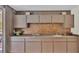 A kitchen with dated cabinets, backsplash, and countertops at 1316 Cambron Dr, Valrico, FL 33596