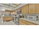 Bright kitchen featuring modern appliances, light wood cabinets, and ample counter space at 1316 Cambron Dr, Valrico, FL 33596