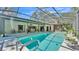 Full view of the screened in pool, with the house and back yard in the background at 1316 Cambron Dr, Valrico, FL 33596